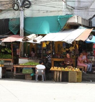 A group of people standing around a market